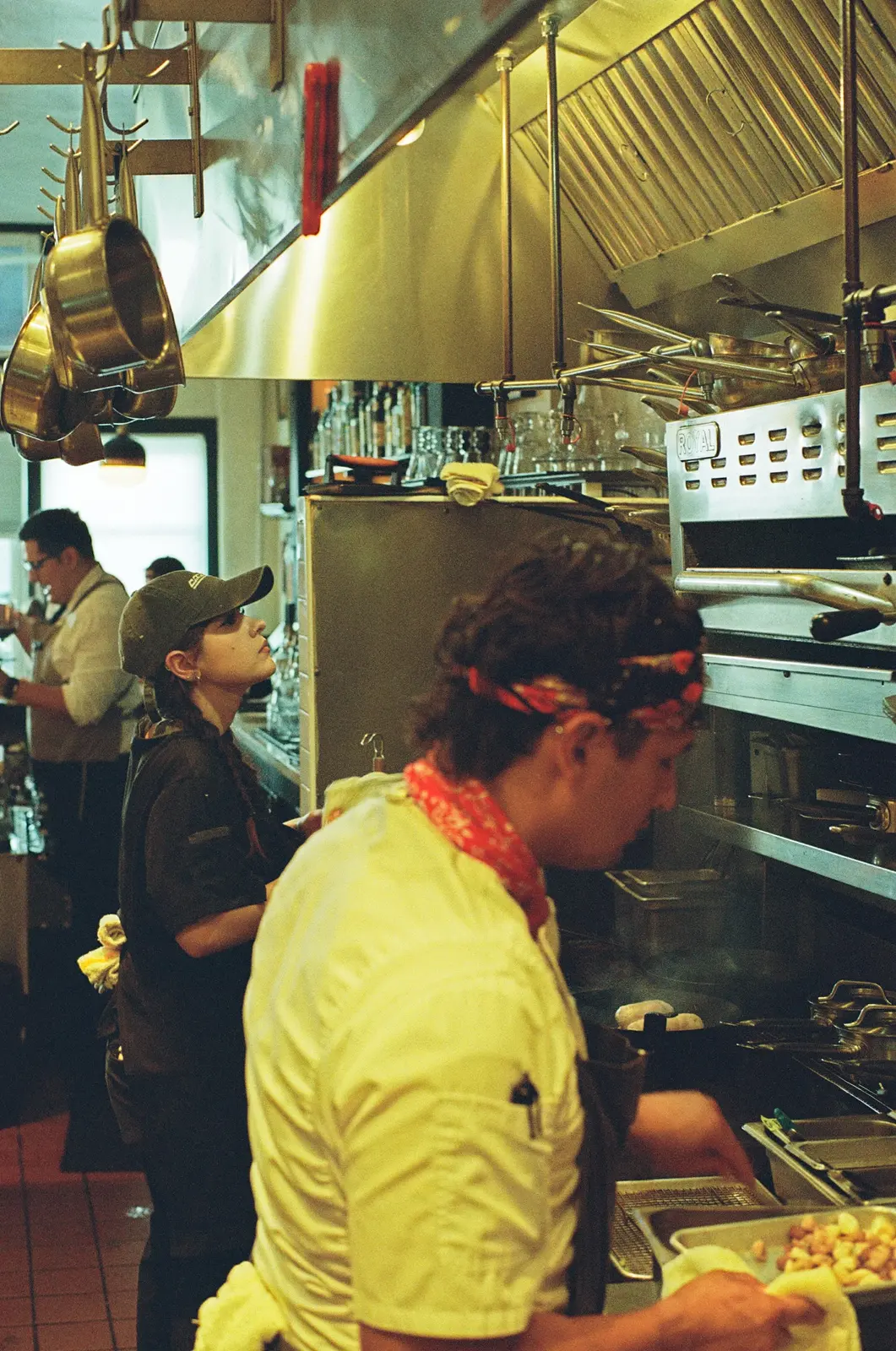 Restaurant professionals coordinating during kitchen service