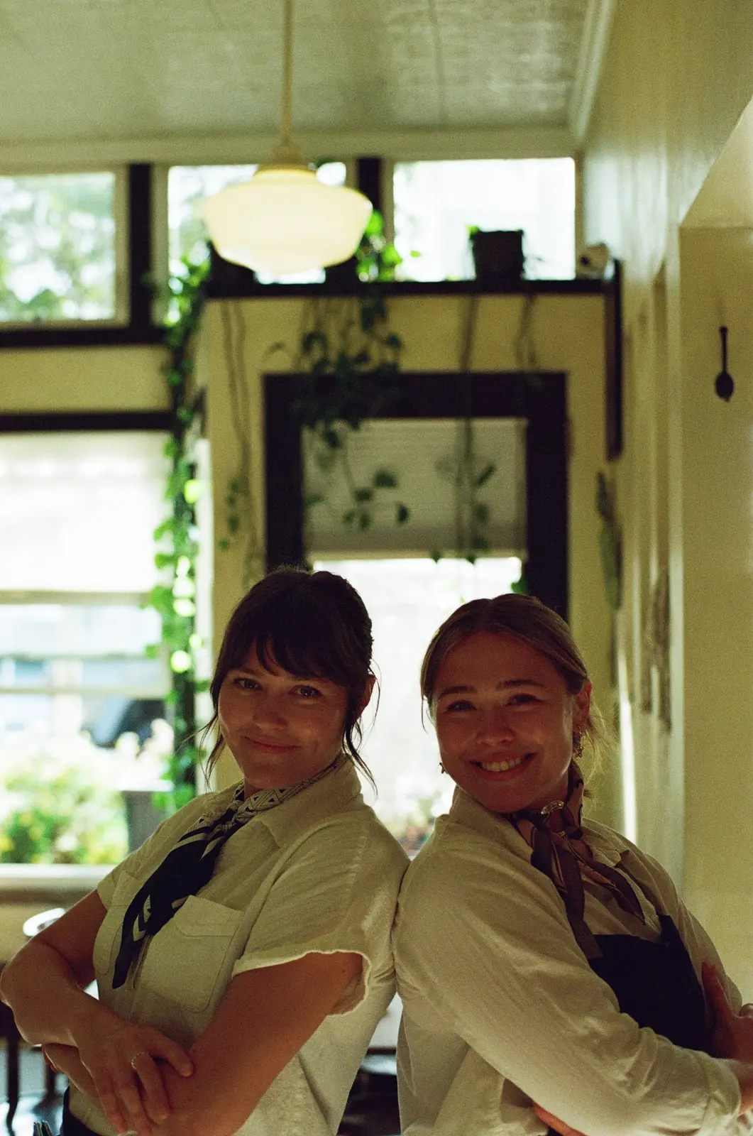 Two restaurant team members smiling together