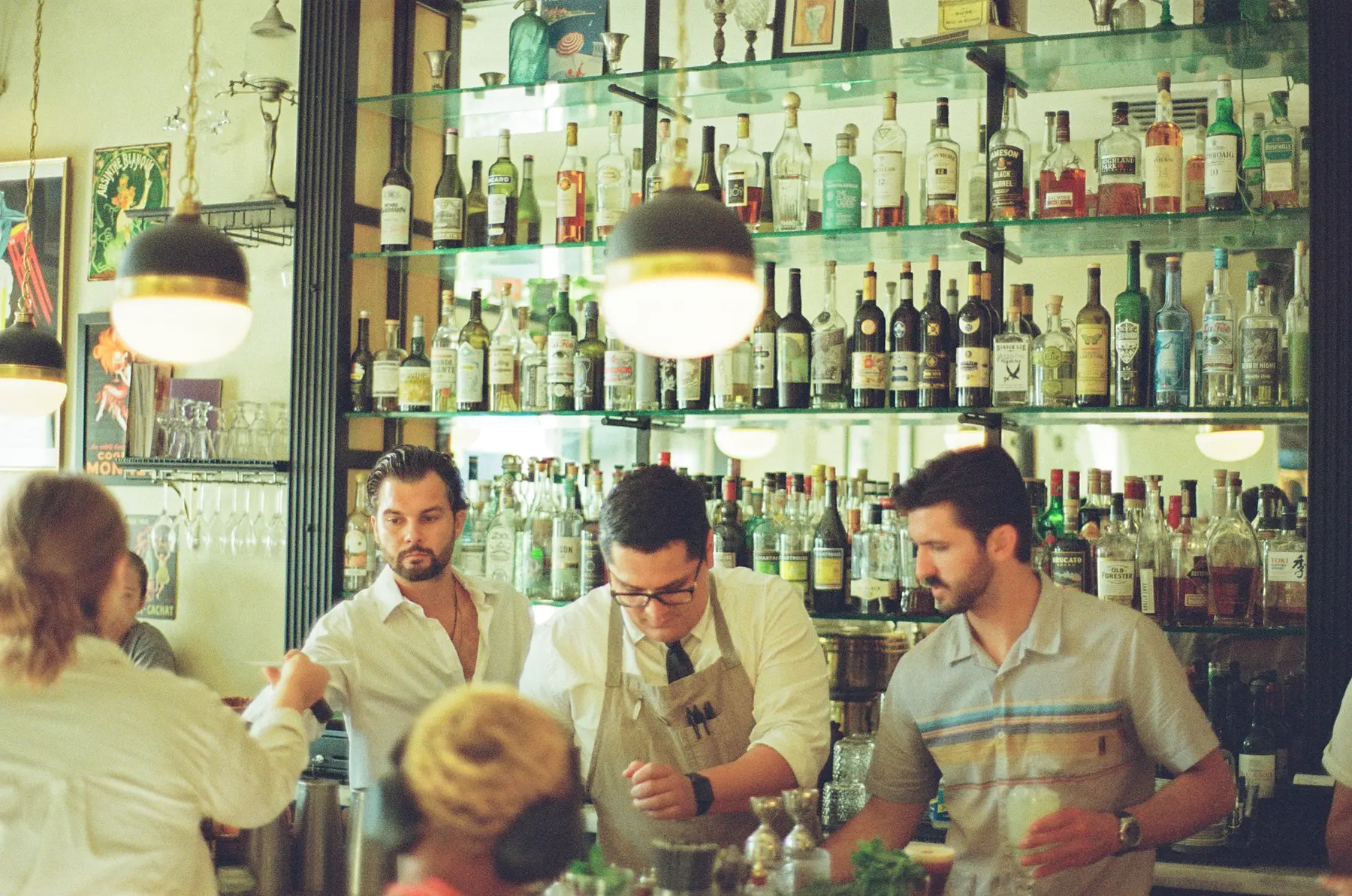 Restaurant team members working together behind a busy bar